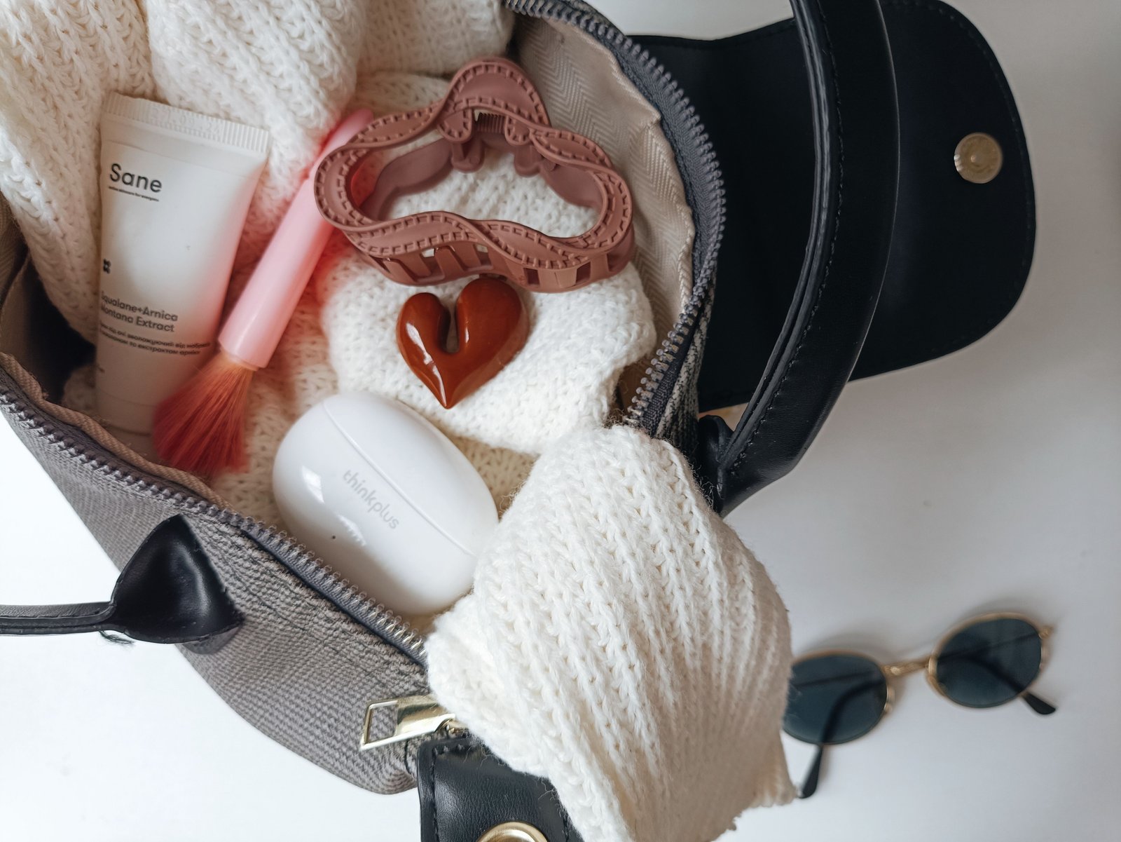 Travel-sized deodorant inside a compact toiletry bag packed for a trip, showcasing essential travel hygiene products