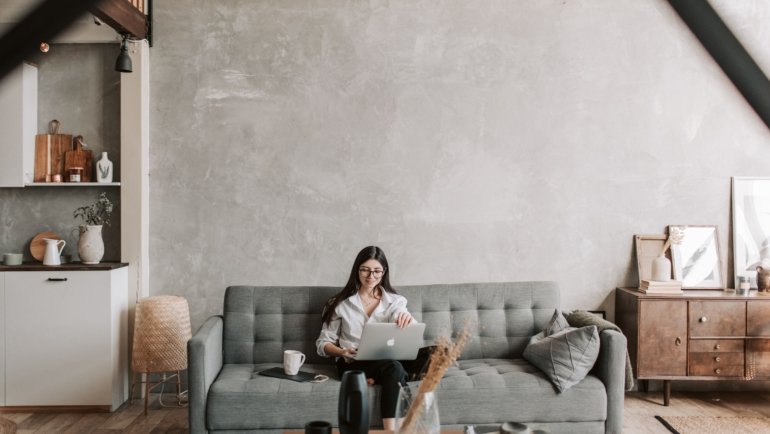 Travel nurse relaxing in a comfortable rented apartment with a fully equipped workspace and luggage, illustrating flexible and homelike Airbnb accommodation for nursing assignments