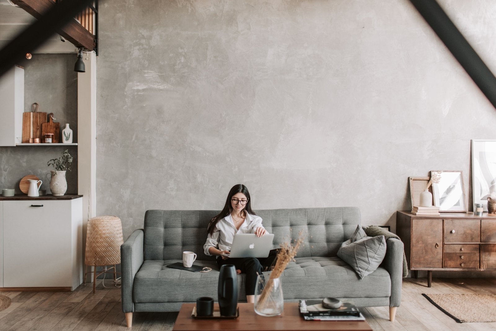 Travel nurse relaxing in a comfortable rented apartment with a fully equipped workspace and luggage, illustrating flexible and homelike Airbnb accommodation for nursing assignments