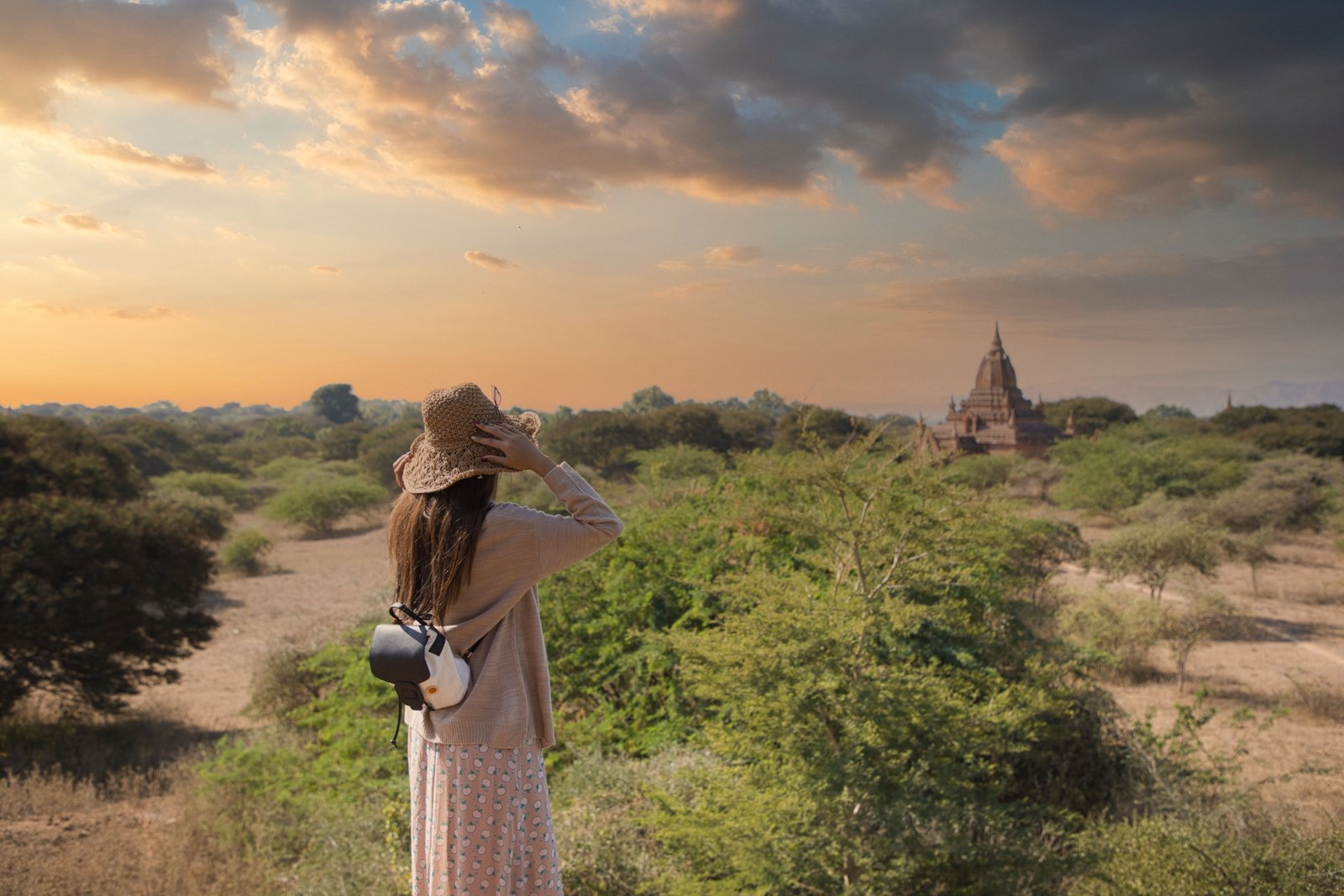 Traveler holding travel insurance documents in Myanmar with landmarks in the background symbolizing protection and peace of mind