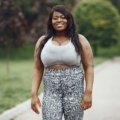 Plus size woman wearing stretchy and breathable travel pants hiking outdoors comfortably