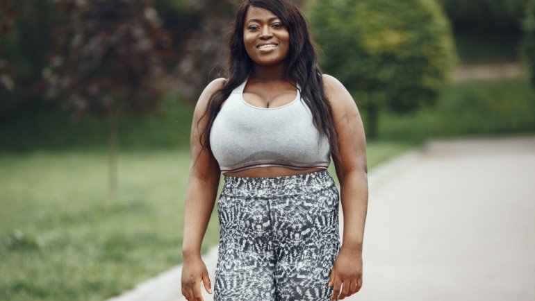 Plus size woman wearing stretchy and breathable travel pants hiking outdoors comfortably