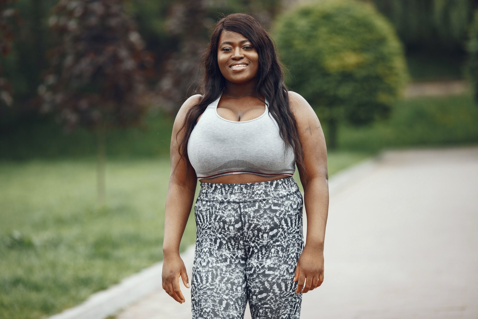Plus size woman wearing stretchy and breathable travel pants hiking outdoors comfortably