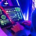 Traveler protecting personal data on laptop with secure cybersecurity measures at airport
