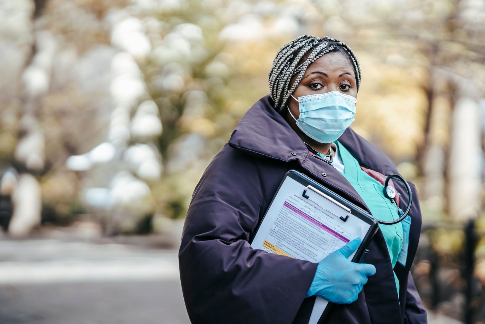 Travel nurse smiling confidently in an urban setting, symbolizing flexible and rewarding travel nursing opportunities
