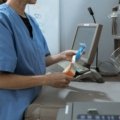 Pharmacy technician working in a hospital with travel bag symbolizing travel healthcare career opportunities