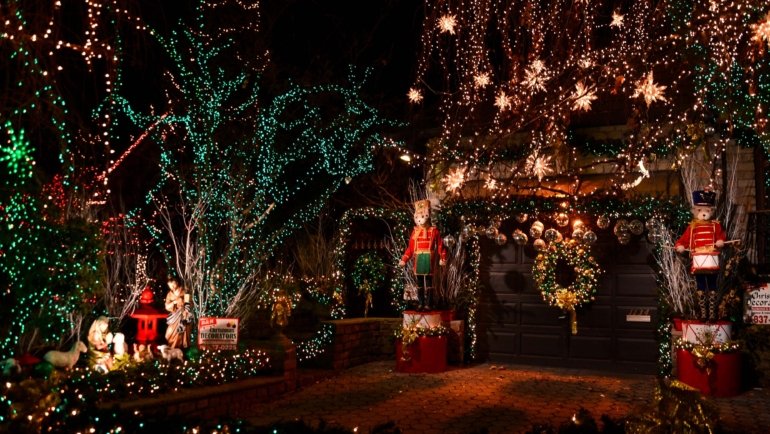 New York City street decorated with Christmas lights and festive holiday decorations at night