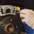 Close-up of electric drum brakes on a travel trailer being inspected for maintenance and safety