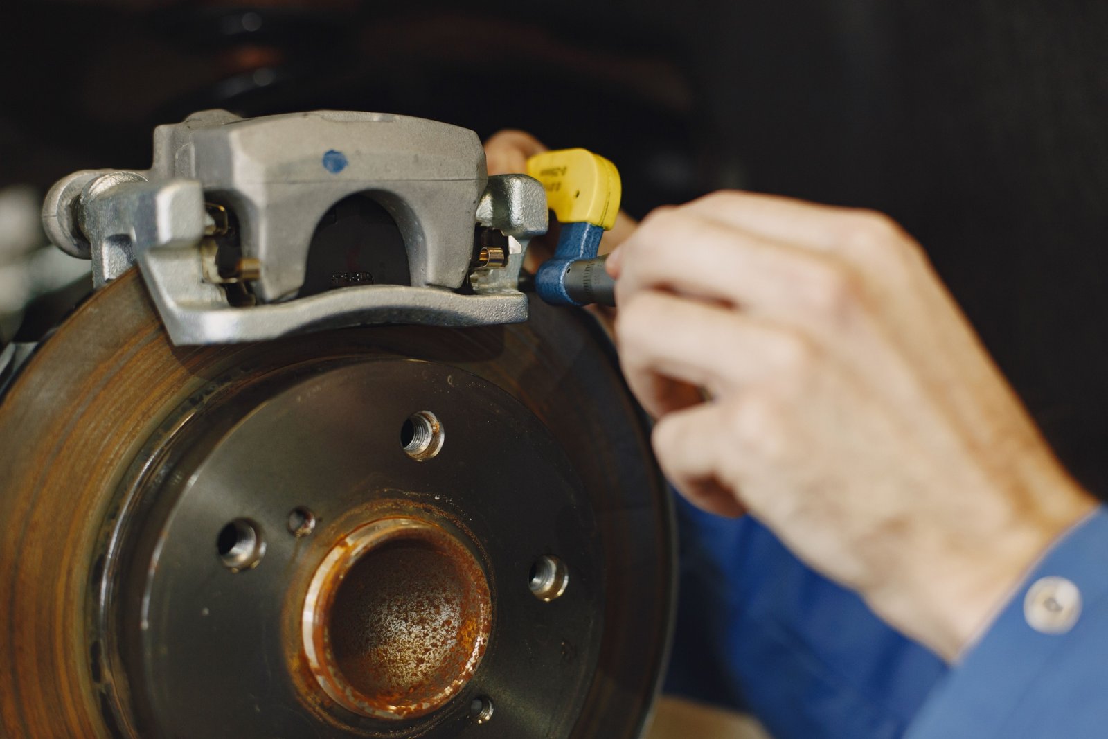 Close-up of electric drum brakes on a travel trailer being inspected for maintenance and safety