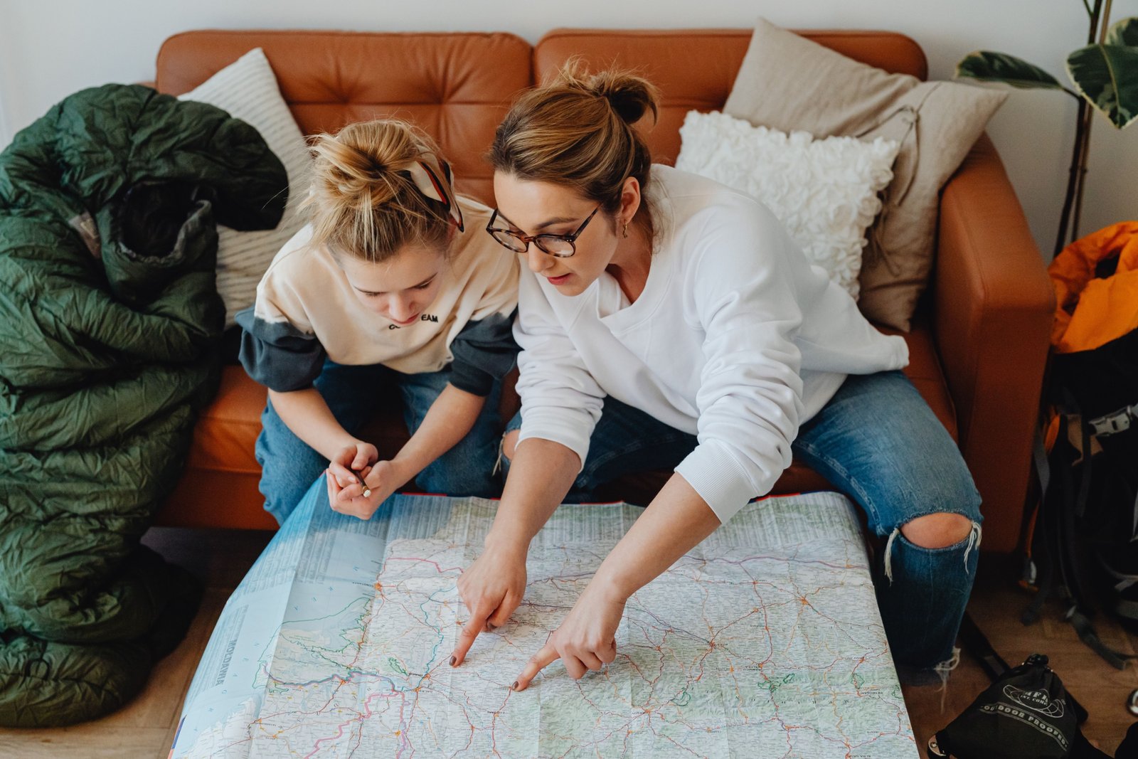 Travel agent helping family plan vacation with maps and brochures, showcasing personalized travel planning in Chattanooga TN