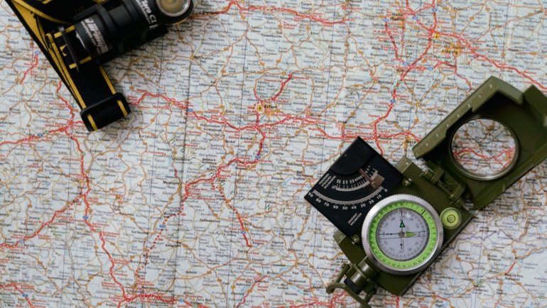 Close-up of a hands holding an RV travel map with marked routes and campgrounds for an adventurous road trip