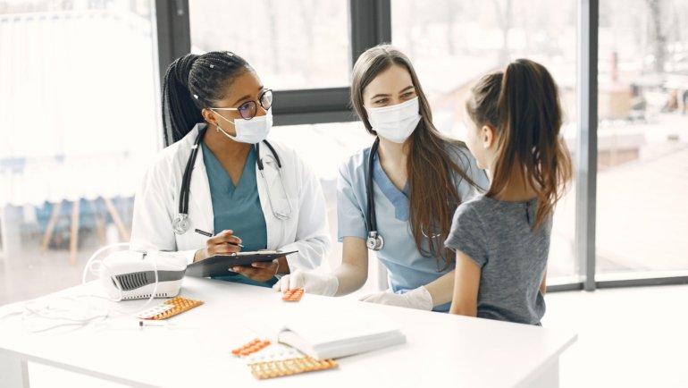 Pediatric intensive care nurse providing critical care to a young patient in a hospital intensive care unit