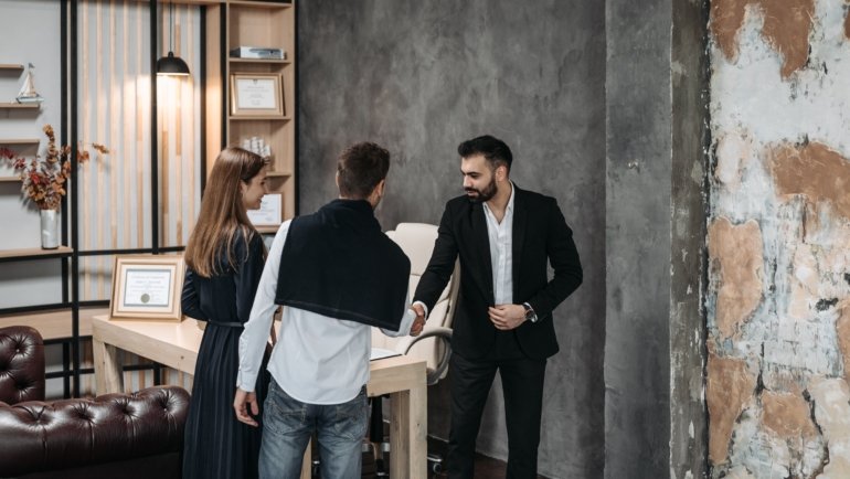 Travel agency consultant discussing personalized travel plans with clients in a modern office