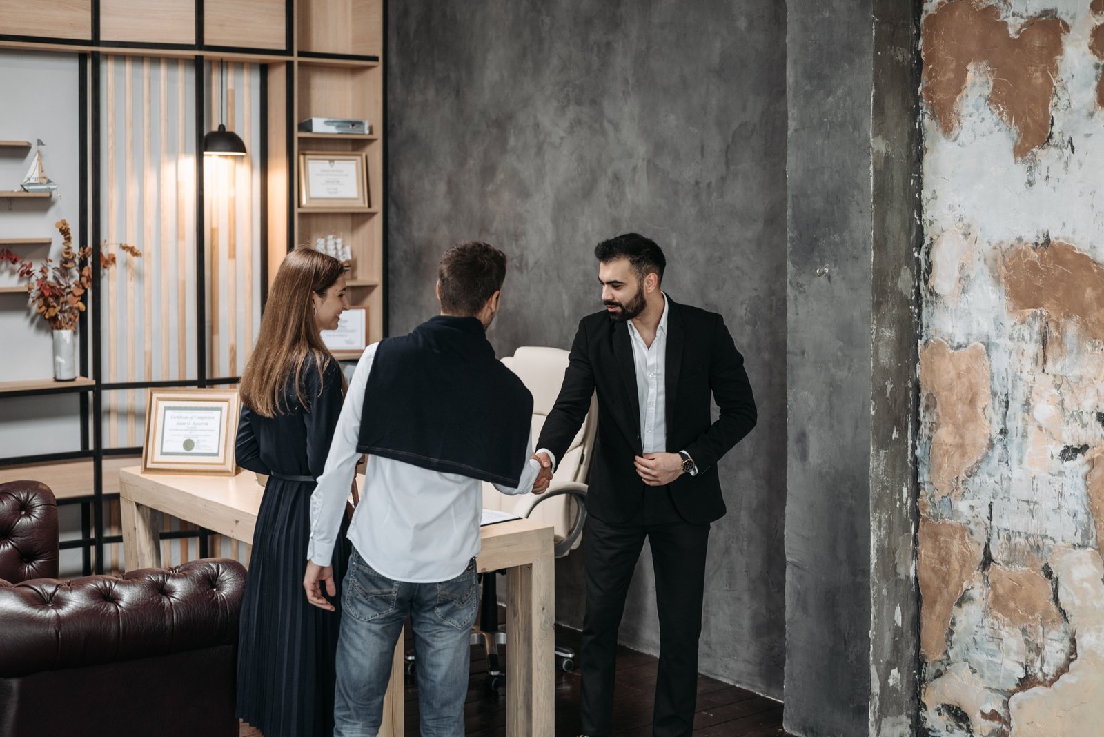 Travel agency consultant discussing personalized travel plans with clients in a modern office