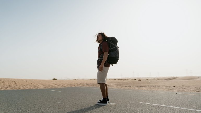 Traveler wearing Royal Robbins Active Traveler Zip N Go pants with legs zipped off hiking outdoors